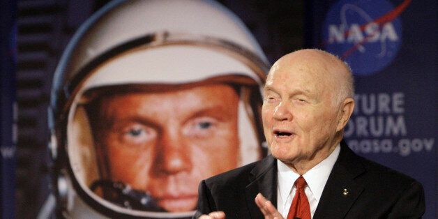 FILE - In this Feb. 20, 2012, file photo, U.S. Sen. John Glenn talks with astronauts on the International Space Station via satellite in Columbus, Ohio. Changing Port Columbusâ name to John Glenn Columbus International Airport will cost an estimated $775,000 in new signs, according to a newly released study. The airport was named in honor of the astronaut and former U.S. senator in June 2016. The 95-year-old Ohio native was the first American to orbit the earth. (AP Photo/Jay LaPrete, File)