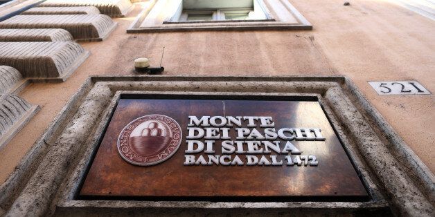 A sign hangs above the entrance to a branch of Banca Monte dei Paschi di Siena SpA bank after the Italian vote on constitutional reform referendum in Rome, Italy, on Monday, Dec. 5, 2016. Banca Monte dei Paschi di Siena SpA shares seesawed on Monday after Prime Minister Matteo Renzis decision to resign added to uncertainty about the banks plans to raise as much as 5 billion euros ($5.3 billion) in capital by the end of the year. Photographer: Chris Ratcliffe/Bloomberg via Getty Images