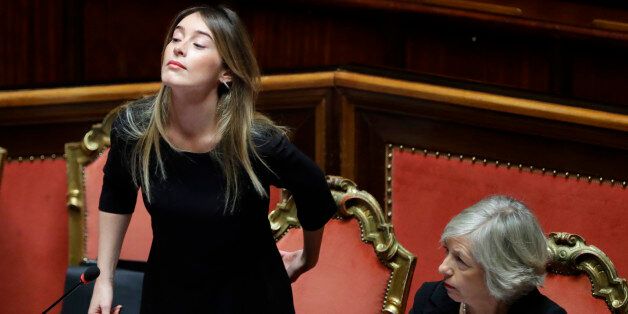 Italian Minister of Constitutional Reforms and Relations with Parliament, Maria Elena Boschi, left, flanked by Education Minister Stefania Giannini attend a session of the Senate in Rome, Wednesday, Dec. 7, 2016. Calls have mounted rapidly from populist and other opposition leaders for quick elections in Italy, seeking to capitalize on Premier Matteo Renziâs humiliating defeat in a referendum on government-championed reforms. The president, though, told Renzi to stay in office a bit longer until a critical budget law is passed. (AP Photo/Alessandra Tarantino)