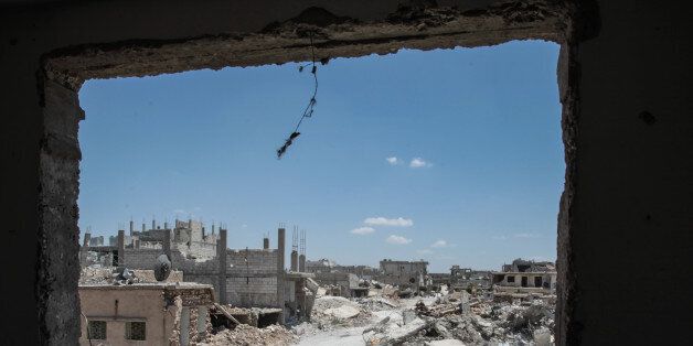 TAL ABYAD, SYRIA - JUNE 20: (TURKEY OUT) The picture shows the wreckage left by fighting on a street in the center of the Syrian town of Kobane, also known as Ain al-Arab, Syria. June 20, 2015. Kurdish fighters with the YPG took full control of Kobane and strategic city of Tal Abyad, dealing a major blow to the Islamic State group's ability to wage war in Syria. Mopping up operations have started to make the town safe for the return of residents from Turkey, after more than a year of Islamic State militants holding control of the town. (Photo by Ahmet Sik/Getty Images)