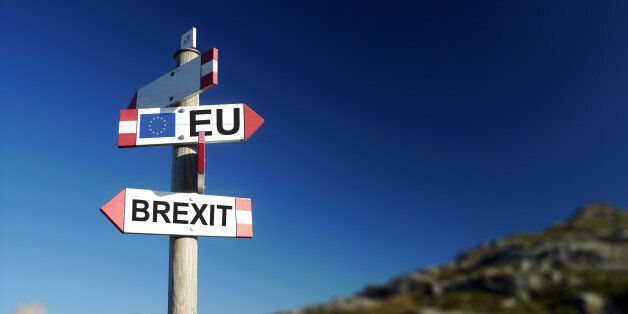 Brexit concept. Brexit and EU flag on mountain road sign.