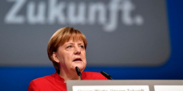 German Chancellor Angela Merkel speaks during a general party conference of the Christian Democratic Union (CDU) in Essen, Germany, Tuesday, Dec. 6, 2016. Merkel wants to secure the backing of her conservative party to head up the party's campaign for next September's election. Word in the background reads 'Future'. (AP Photo/Martin Meissner)