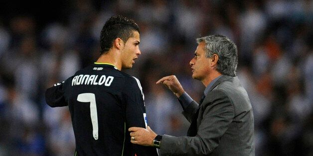 Real Madrid's coach Jose Mourinho gives instructions to Cristiano Ronaldo during their Spanish First Division soccer match against Real Sociedad at the Anoeta stadium in San Sebastian September 18, 2010. REUTERS/Felix Ordonez (SPAIN - Tags: SPORT SOCCER)