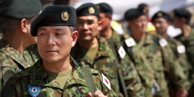 Members of the Japan Self-Defense Forces arrive as part of a first batch who have a broader mandate to use force, at the airport in Juba, South Sudan Monday, Nov. 21, 2016. Japanese peacekeepers, with a broader mandate to use force, landed in South Sudan in the first such deployment of the country's troops overseas with those expanded powers in nearly 70 years. (AP Photo/Justin Lynch)