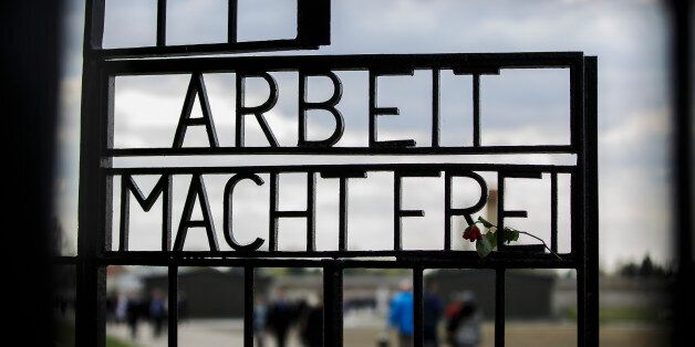 ORANIENBURG, GERMANY - APRIL 19: 'Arbeit Macht Frei' ('Work Makes Free') inscription at the original entrance gate during ceremonies marking the 70th anniversary of the liberation of Sachsenhausen at the former Sachsenhausen concentration camp near Berlin on April 19, 2015 in Oranienburg, Germany. The Nazis ran Sachsenhausen from 1936-1945, using it initially for political prisoners, then later also for resistance fighters from across Europe, Soviet prisoners of war, Jews, homosexuals, Jehova's Witnesses and other victims. The camp included a gas chamber, execution pit and ovens for burning bodies, and an estimated 30,000 inmates died. Soviet and Polish forces liberated the camp on April 22, 1945. (Photo by Thomas Trutschel/Photothek via Getty Images)