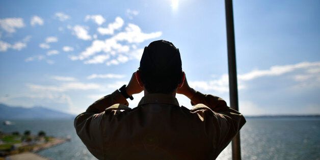 IZMIR, TURKEY - MAY 26: A soldier of the German Navy looks through a binocular while on board of the German combat support ship 'Bonn' at the port of Izmir on May 26, 2016 in Izmir, Turkey. NATO's Standing Maritime Group 2 is currently deployed in the region between the mainland of Greece and Turkey, and will conduct surveillance and monitor illegal crossings in the Aegean Sea. The number of attempts by refugees to reach the islands of Greece has dropped rapidly. (Photo by Alexander Koerner/Gett