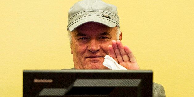 FILE - In this Friday, July 4, 2011, file photo former Bosnian Serb Gen. Ratko Mladic waves as he sits in the court room during his initial appearance at the U.N.'s Yugoslav war crimes tribunal in The Hague, Netherlands. UN prosecutors deliver their closing statement in the marathon genocide trial of former Bosnian Serb military chief Gen. Ratko Mladic, who is accused of commanding forces responsible for the worst atrocities of the Bosnian war. (AP Photo/ Valerie Kuypers, Pool, File)
