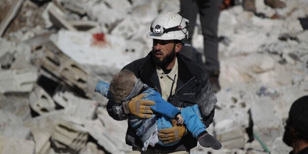 QUALITY REPEAT ATTENTION EDITORS - VISUAL COVERAGE OF SCENES OF DEATH AND INJURY A civil defence member carries a dead child in a site hit by what activists said were air strikes carried out by the Russian air force in the rebel-controlled area of Maaret al-Numan town in Idlib province, Syria January 9, 2016. REUTERS/Khalil Ashawi/File Photo