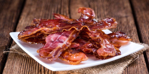 Fried Bacon (selective focus) on an old vintage wooden table