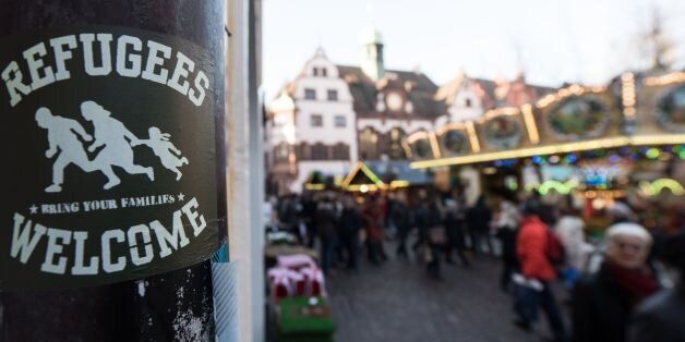 A sticker reading 'Refugees Welcome' is fixed on a pole on December 5, 2016 in Freiburg, southwestern Germany.The German government pleaded for calm after the arrest of a teenage Afghan asylum seeker for the alleged rape and murder of a German student in Freiburg triggered fresh criticism of the country's liberal refugee policy. / AFP / dpa / Patrick Seeger / Germany OUT (Photo credit should read PATRICK SEEGER/AFP/Getty Images)