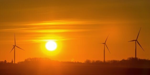 A picture shows wind turbines as the sun rises in Leury, northern France, on November 30, 2016. / AFP / PHILIPPE HUGUEN (Photo credit should read PHILIPPE HUGUEN/AFP/Getty Images)