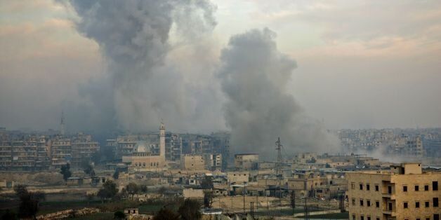 Smoke billows from the former rebel-held district of Bustan al-Qasr in Aleppo, on December 12, 2016, during an operation by Syrian government forces to retake the embattled city. The crucial battle for Aleppo entered its 'final phase' after Syrian rebels retreated into a small pocket of their former bastion in the face of new army advances. The retreat leaves opposition fighters confined to just a handful of neighbourhoods in southeast Aleppo, the largest of them Sukkari and Mashhad. / AFP / STRINGER (Photo credit should read STRINGER/AFP/Getty Images)