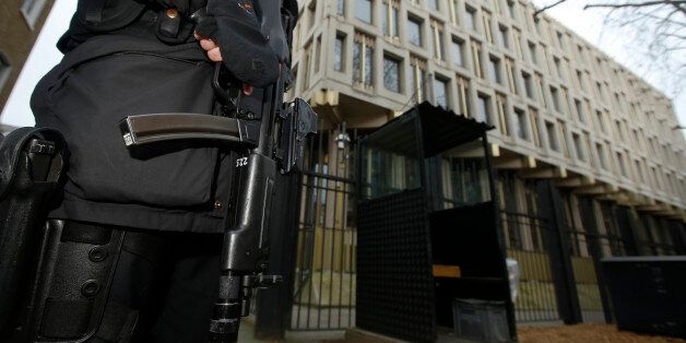 A police officer patrols outside the U.S. embassy in London December 9, 2014. The Senate Intelligence Committee prepared to release a report on the CIA's anti-terrorism tactics on Tuesday and U.S. officials moved to shore up security at American facilities around the world as a precaution. REUTERS/Luke MacGregor (BRITAIN - Tags: POLITICS CONFLICT MILITARY CRIME LAW)