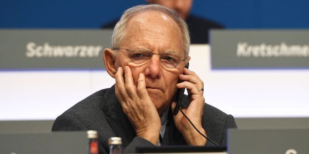 German Finance Minister Wolfgang Schaeuble gives a phone call during the Christian Democratic Union (CDU) party's congress in Essen, western Germany, on December 7, 2016.Party members gave Angela Merkel a standing ovation lasting more than 11 minutes but also dealt a blow in re-electing her as party chief with her worst score, 89.5 percent, since she became chancellor of Germany. / AFP / Patrik STOLLARZ (Photo credit should read PATRIK STOLLARZ/AFP/Getty Images)