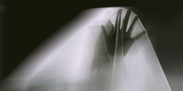 A ghostly apparition of a woman isolated on a black background