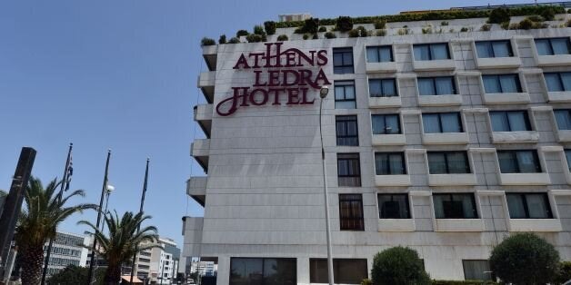 A man walks past the luxury Athens Ledra Hotel following its closure on June 2, 2016. The Athens central Athens Ledra Hotel, announced the closure of the 314-room establishment, citing 'financial difficulties'. More than 150 Athens Ledra employees have not been paid since March. / AFP / LOUISA GOULIAMAKI (Photo credit should read LOUISA GOULIAMAKI/AFP/Getty Images)