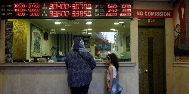 A board shows exchange rates at a foreign currency shop in central Istanbul, Thursday July 21, 2016. Turkey's central bank has cut a key interest rate to help shore up the economy, days after an attempted coup. Turkish stocks are way down from pre-coup levels, as is the Turkish lira. Turkish lawmakers convened to endorse sweeping new powers for President Recep Tayyip Erdogan, that would allow him to expand a crackdown in the wake of the July 15 failed coup. (AP Photo/ Emrah Gurel)