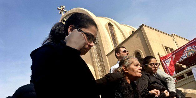 Coptic Christian woman leave after a funeral service for victims of a Sunday cathedral bombing, at the Virgin Mary Church, in Cairo, Egypt, Monday, Dec. 12, 2016. Egypt's president says a suicide bomber caused the explosion that killed 24 Christians during Sunday Mass at a Cairo chapel. President Abdel-Fattah el-Sissi says three men and a woman were arrested in connection with the attack at a chapel adjacent to Cairo's St Mark's Cathedral, the seat of the Coptic Orthodox Church. (AP Photo/Nariman El-Mofty)