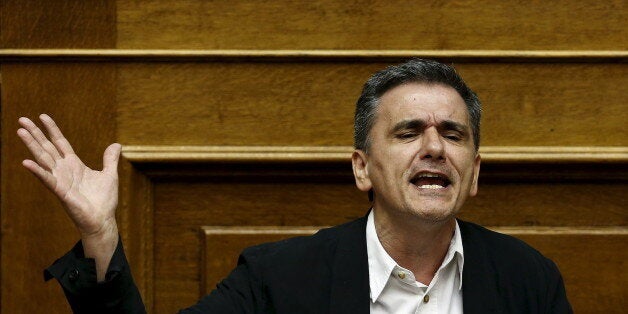 Greek Finance Minister Euclid Tsakalotos addresses lawmakers during a parliamentary session in Athens, Greece July 22, 2015. Greece's leftist government tried on Wednesday to contain a rebellion in Prime Minister Alexis Tsipras' Syriza party ahead of a vote in the evening on reforms required to start talks on a rescue deal. REUTERS/Yiannis Kourtoglou TPX IMAGES OF THE DAY