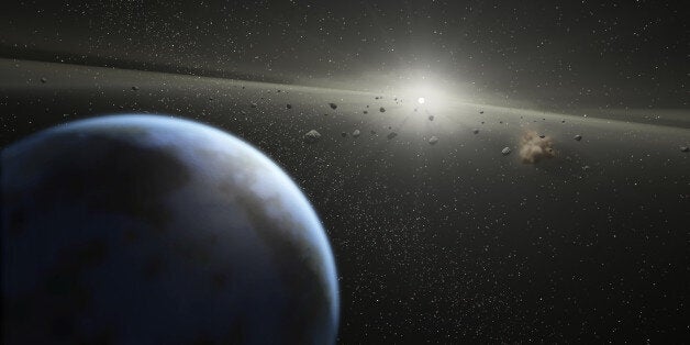 SPACE - UNDATED: An artists impression showing an asteroid belt around a star similar in size to the sun. MEET Brit Lightyear - the British spaceman who could be called upon to save the world from Armageddon. Major Tim Peake, 40 - Britain's first official astronaut - is part of a specialist team training to land on an asteroid, just like in the Hollywood blockbuster starring Bruce Willis. Their research could prove vital in preventing a catastrophic collision that would see life on earth wiped out. The mission, carried out by NASA Extreme Environment Missions Operations, will eventually see the a manned shuttle propelled up to three million miles into space. There they will reach speeds of up to 55,000mph through a swing-by - where a planets gravity is used to increase speed - as they attempt to dock on the surface and carry out crucial research. But should an meteorite find itself on a catastrophic collision course with earth, a manned mission could be used to deflect it. And Brit Tim would be in line to answer the call as bruce Willis' oil magnate character did in the hit film Armageddon. PHOTOGRAPH BY NASA / Barcroft Media /Barcoft Media via Getty Images