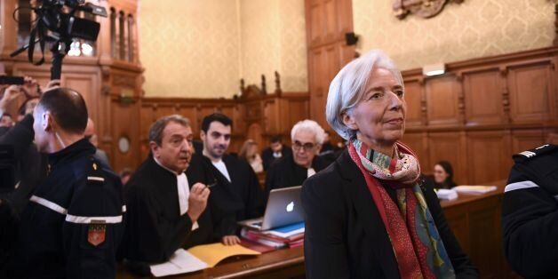 IMF chief Christine Lagarde (R) and her lawyer Patrick Maisonneuve (Rear L) look on in a courtroom of the Paris courthouse on December 12, 2016 prior to the start of Lagarde's trial before the Court of Justice of the Republic, a special tribunal used to try ministers.IMF chief Christine Lagarde goes on trial in France on December 12 over a massive state payout to a flamboyant tycoon when she was finance minister in a case that risks tarnishing her stellar career. / AFP / Martin BUREAU (Photo credit should read MARTIN BUREAU/AFP/Getty Images)
