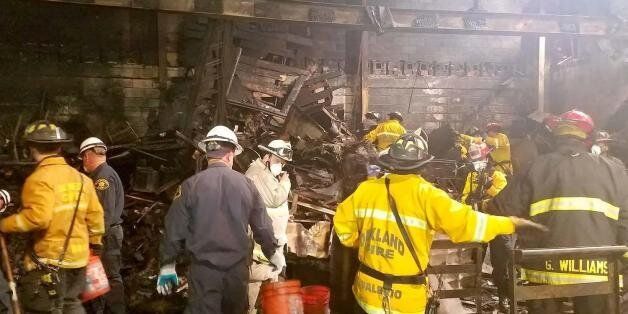 This photo provided by the City of Oakland shows inside the burned warehouse after the deadly fire that broke out on Dec. 2, 2016, in Oakland, Calif. The death toll in the fire climbed Monday, Dec. 5, with more bodies still feared buried in the blackened ruins, and families anxiously awaited word of their missing loved ones. (City of Oakland via AP)
