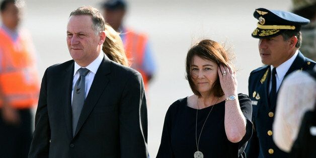 New Zealand's Prime Minister John Key and his wife Bronagh Key smile upon arrival at the Jorge Chavez International Airport in Lima, on November 18, 2016 to attend the Asia-Pacific Economic Cooperation (APEC) Summit.Asia-Pacific leaders were urged to defend free trade from rising protectionism after the election victory of Donald Trump stoked fears that years of tearing down barriers to global commerce could be reversed. / AFP / LUKA GONZALEZ (Photo credit should read LUKA GONZALEZ/AFP/Getty Images)