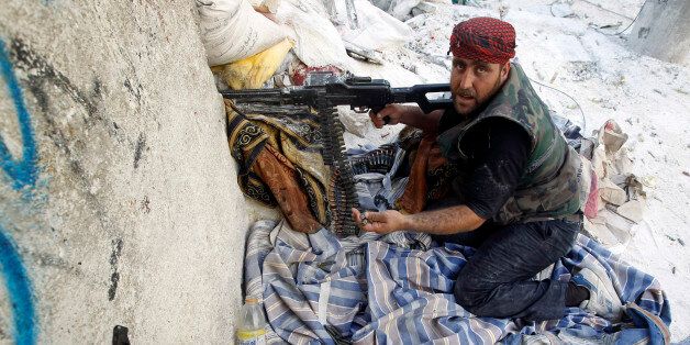 A Free Syrian Army fighter gestures during a fight with forces loyal to Syrian President Bashar Al-Assad in downtown Aleppo August 1, 2012. REUTERS/Goran Tomasevic (SYRIA - Tags: CIVIL UNREST POLITICS CONFLICT)