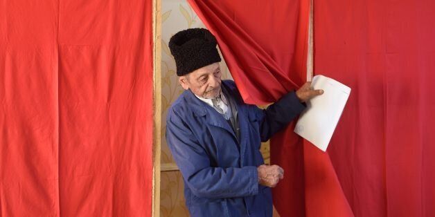 An elderly man leaves a polling booth to cast his ballot at a polling station in the village of Singureni, Romania, December 11, 2016.Romanians started voting in parliamentary elections that are forecast to see the corruption-tainted left stage a remarkable comeback, a year after a deadly nightclub fire forced them from office. / AFP / DANIEL MIHAILESCU (Photo credit should read DANIEL MIHAILESCU/AFP/Getty Images)