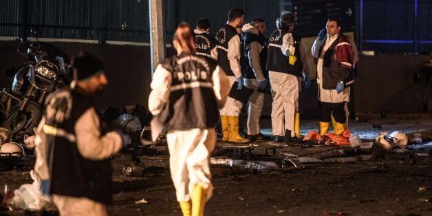 Turkish forensic police officers work on the site where a car bomb exploded near the stadium of football club Besiktas in central Istanbul on December 10, 2016. The car bomb exploded in the heart of Istanbul on late December 10, wounding around 20 police officers, Turkey's interior minister said, quoted by the official Anadolu news agency. The bomb, apparently targeting a bus carrying police officers, exploded outside the stadium of Istanbul football club Besiktas following its match against Bu