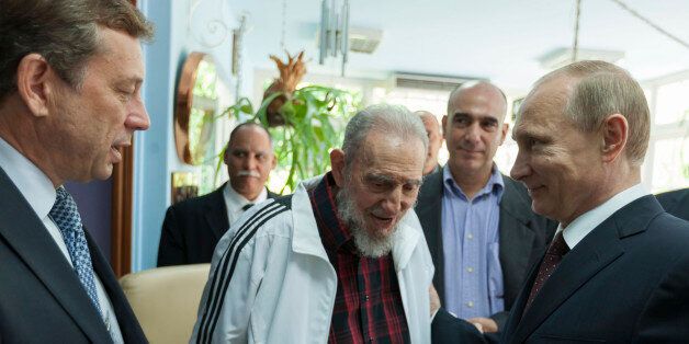 Cuba's former President Fidel Castro (C) talks with Russia's President Vladimir Putin (R) during a meeting in Havana in this undated handout photograph released to Reuters on July 11, 2014. Putin pledged to help revive Cuba's struggling offshore oil exploration on Friday at the start of a six-day tour of Latin America as Russia aims to reassert its influence on the communist-ruled island. REUTERS/Cubadebate/Handout via Reuters (CUBA - Tags: POLITICS) ATTENTION EDITORS - FOR EDITORIAL USE ONLY. NOT FOR SALE FOR MARKETING OR ADVERTISING CAMPAIGNS. THIS PICTURE WAS PROVIDED BY A THIRD PARTY. REUTERS IS UNABLE TO INDEPENDENTLY VERIFY THE AUTHENTICITY, CONTENT, LOCATION OR DATE OF THIS IMAGE. THIS PICTURE IS DISTRIBUTED EXACTLY AS RECEIVED BY REUTERS, AS A SERVICE TO CLIENTS