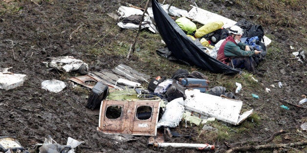 A rescue worker sits near the wreckage of a plane that crashed into the Colombian jungle with Brazilian soccer team Chapecoense onboard near Medellin, Colombia, November 29, 2016 REUTERS/Jaime Saldarriaga