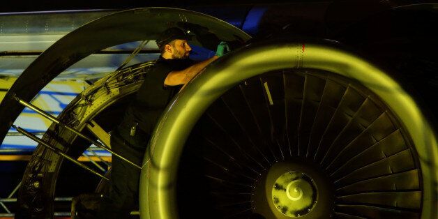 An aircraft technician carries out maintenance on the engine of an airplane inside a Lufthansa Technik hangar at Malta International Airport outside Valletta, Malta, November 23, 2016. REUTERS/Darrin Zammit Lupi MALTA OUT. NO COMMERCIAL OR EDITORIAL SALES IN MALTA