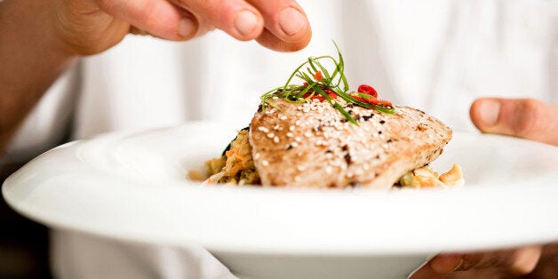 Chef adding final touch to tuna appetizer