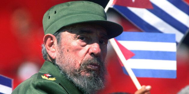 Then Cuban President Fidel Castro glances over his shoulder during the May Day commemoration at Revolution Square in Havana, in this May 1, 2004 file photo. Picture taken May 1, 2004. REUTERS/Rafael Perez/Files (CUBA - Tags: POLITICS ANNIVERSARY OBITUARY)