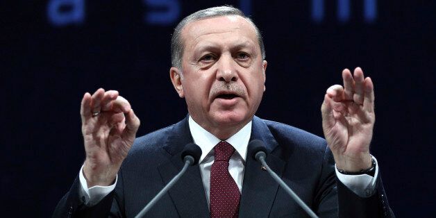 Turkey's President addresses police officers in Ankara, Turkey, Tuesday, Nov. 22, 2016. Turkey's government on Tuesday dismissed a further 15,000 people from the military, police and the civil service as part of an ongoing investigation into the failed military coup in July. Erdogan said Tuesday that the civil service was still not entirely purged of U.S.-based Muslim cleric Fethullah Gulen's followers and vowed take all measures necessary to eradicate the group. (Murat Cetinmuhurdar, Presidential Press Service, Pool photo via AP)