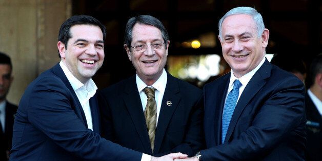 Cypriot president Nicos Anastasides, centre, Greek Prime Minister Alexis Tsipras, left, and Israeli Prime Minister Benjamin Netanyahu shake hands after leaving their meeting from the presidential palace in capital Nicosia in the Mediterranean island of Cyprus, Thursday, Jan. 28, 2016. The leaders of Cyprus, Greece and Israel met in the Cypriot capital with the aim to strengthen cooperation and bolster stability in a region wracked by conflict. The talks are the first tripartite summit. Discussi