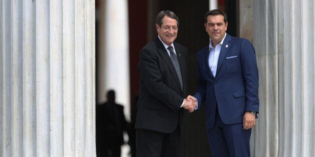 Greek Prime Minister Alexis Tsipras, right, welcomes Cyprus' President Nikos Anastasiades during a Mediterranean Leaders summit in Athens, on Friday, Sept, 9, 2016. (AP Photo/Petros Giannakouris)