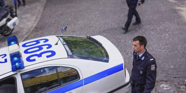 Elevated view of Greek policeman and car