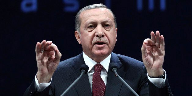 Turkey's President addresses police officers in Ankara, Turkey, Tuesday, Nov. 22, 2016. Turkey's government on Tuesday dismissed a further 15,000 people from the military, police and the civil service as part of an ongoing investigation into the failed military coup in July. Erdogan said Tuesday that the civil service was still not entirely purged of U.S.-based Muslim cleric Fethullah Gulen's followers and vowed take all measures necessary to eradicate the group. (Murat Cetinmuhurdar, Presidential Press Service, Pool photo via AP)