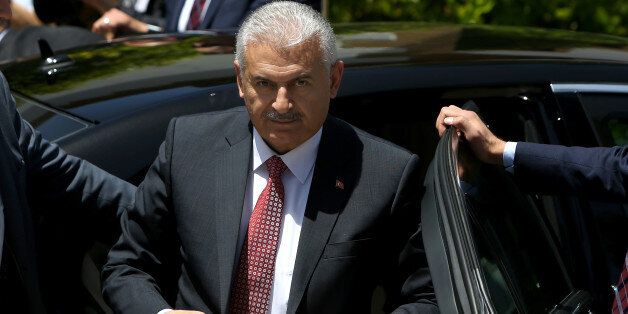 New Turkish Prime Minister Binali Yildirim adjusts his jacket as he arrives for a meeting with the Turkish Cypriot leader Mustafa Akinci at the Turkish Cypriot breakaway northern part of the eastern Mediterranean divided island of Cyprus, Wednesday, June 1, 2016. Yildirim is his first trip in the Turkish Cypriot breakaway part of the island for one-day visit. (AP Photo/Petros Karadjias)