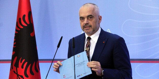 Albania's Prime Minister Edi Rama speaks at a news conference to confirm a compromise has been reached with the opposition on the judiciary reform package, in Tirana, Wednesday, July 20, 2016.ï»¿ International pressure has convinced Albaniaâs main opposition Democratic Party to accept the final draft of a judicial reform package, considered fundamental to convincing the European Union to launch membership negotiations with the Balkan country. (AP Photo/Hektor Pustina)