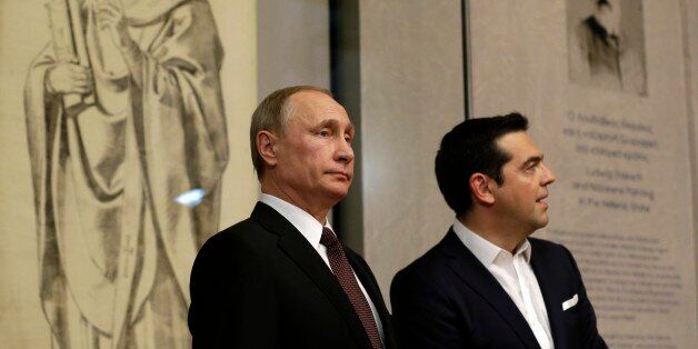 Greek Prime Minister Alexis Tsipras, right, and Russian President Vladimir Putin visit the Byzantine and Christian museum in Athens, Friday, May 27, 2016. Russian President Vladimir Putin has traveled to Greece to visit a secluded Christian Orthodox monastic sanctuary and discuss energy and privatization deals in the cash-strapped country. (AP Photo/Thanassis Stavrakis, Pool)