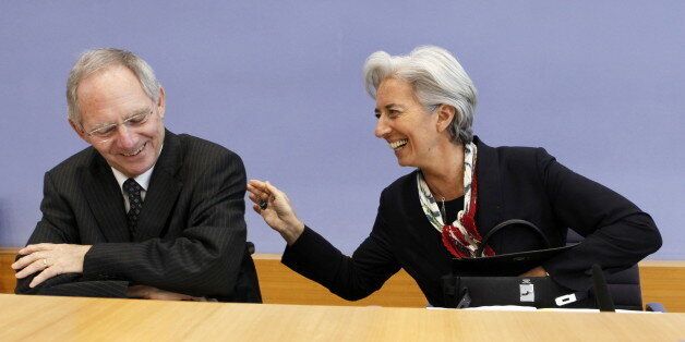 French Finance Minister Christine Lagarde (R) and her German counterpart Wolfgang Schaeuble share a joke as they arrive to address a press conference in Berlin on March 31, 2010. The German government agreed on a new tax on banks for a fund which could be used for bailouts in the event of another banking crisis, Finance Minister Wolfgang Schaeuble said on March 31, 2010. AFP PHOTO DAVID GANNON (Photo credit should read DAVID GANNON/AFP/Getty Images)