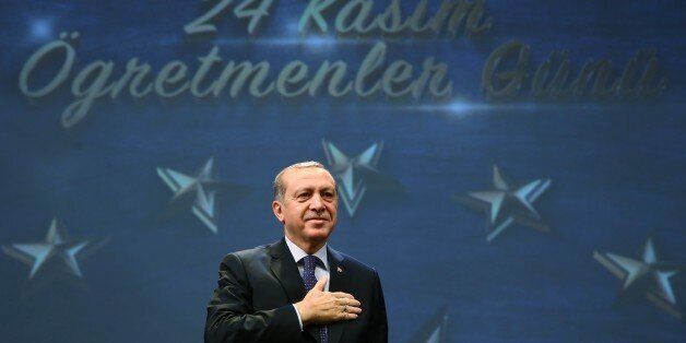 ANKARA, TURKEY - NOVEMBER 24 : Turkish President Recep Tayyip Erdogan salutes the people before addressing a speech to the teachers during a ceremony, marking November 24 Teachers' Day, at Bestepe People's Congress and Culture Center in the Presidential Complex in Ankara, Turkey on November 24, 2016. (Photo by Kayhan Ozer/Anadolu Agency/Getty Images)