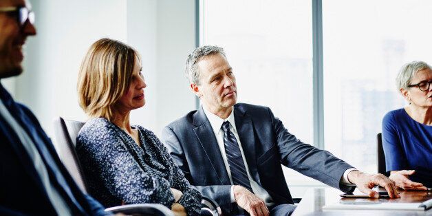 Group of business executives in meeting in office conference room