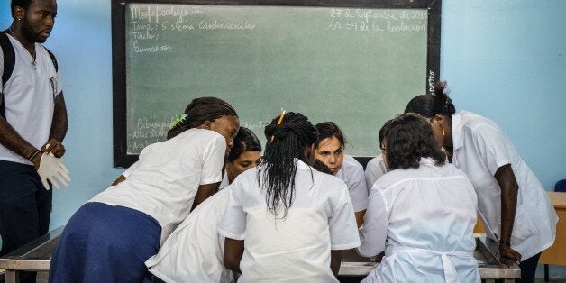 Students take lessons at the Latin American Medicine School (ELAM), on October 14, 2013 in Havana. More than 13,000 students from different countries study at the ELAM. AFP PHOTO/ADALBERTO ROQUE (Photo credit should read ADALBERTO ROQUE/AFP/Getty Images)