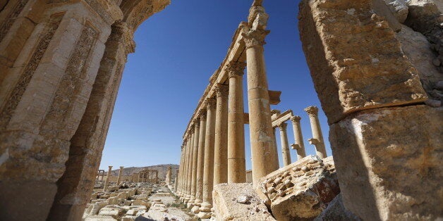 A view shows the damage at the Monumental Arch in the historical city of Palmyra, in Homs Governorate, Syria April 1, 2016. REUTERS/Omar Sanadiki SEARCH