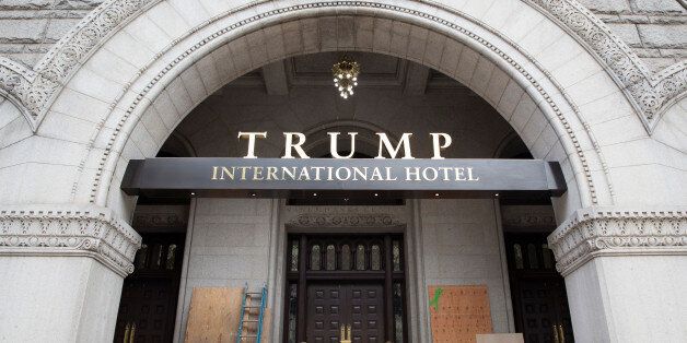 Plywood covers graffiti at an entrance to the Trump International Hotel in Washington, U.S., October 2, 2016. REUTERS/Joshua Roberts