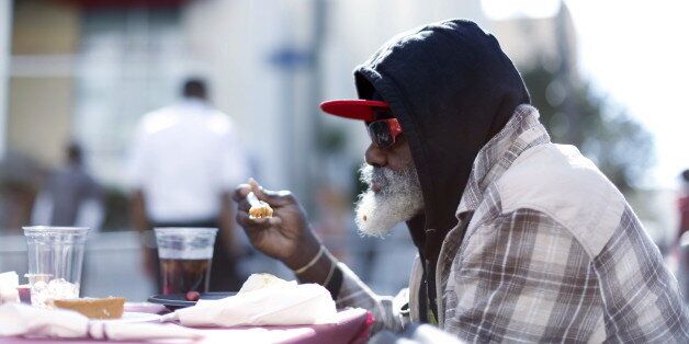 A man eats an early Thanksgiving meal served to the homeless at the Los Angeles Mission in Los Angeles, California, November 25, 2015. REUTERS/Mario Anzuoni